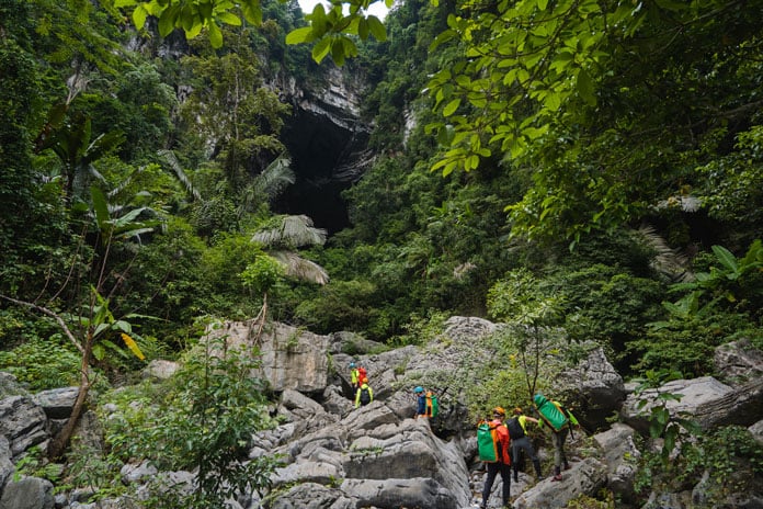 The rocky terrain leads to the Hang Tien Cave entrance