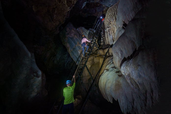 At the end of  Hang Tien Cave 1, you will climb up a 10m high ladder with safety harnesses, leading to the cave exit