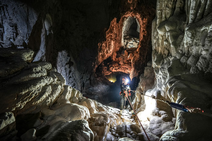 Abseiling with safety equipment in Son Doong Cave
