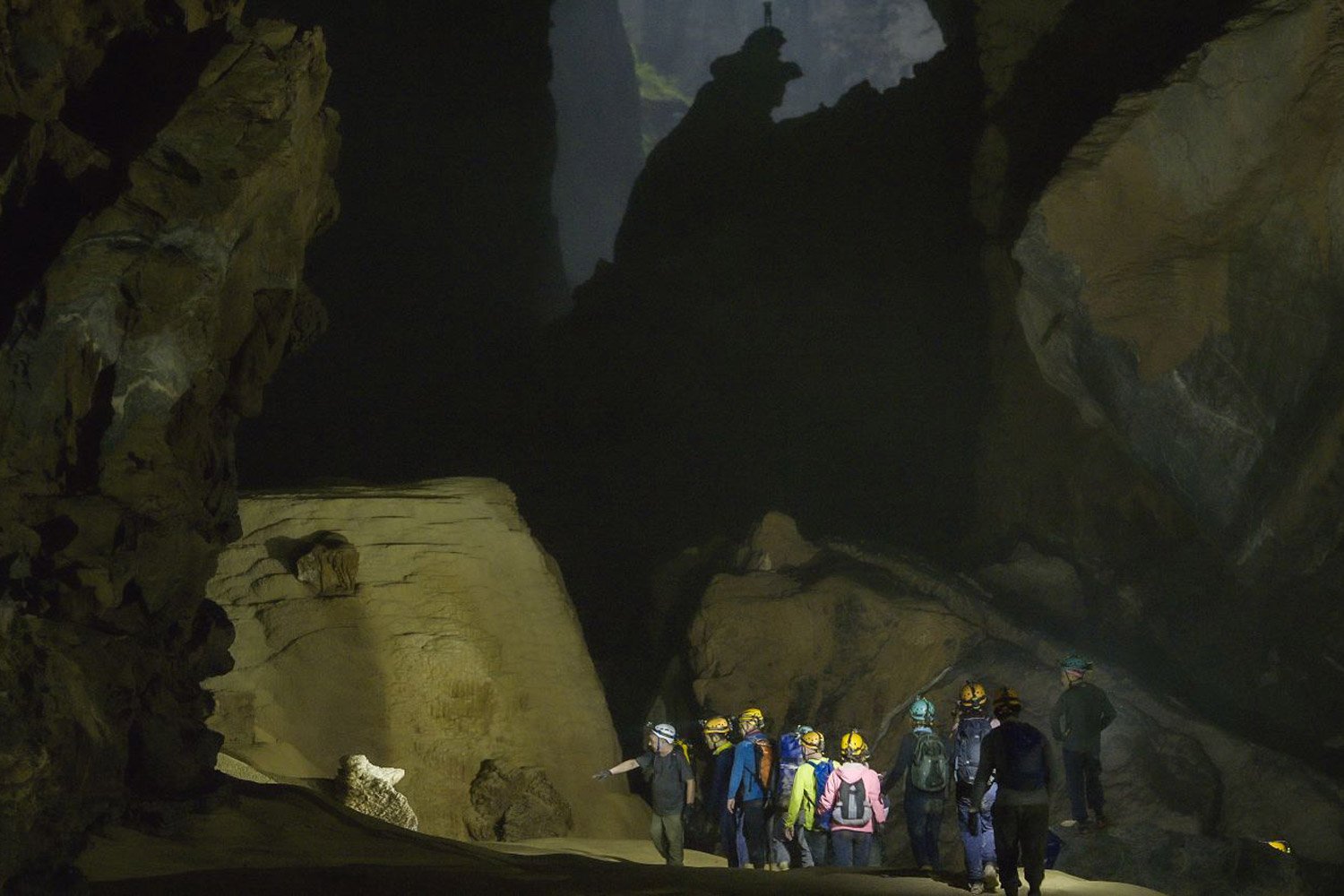 Visitors are exploring near the Hand of Dog stalagmite in Son Doong Cave.